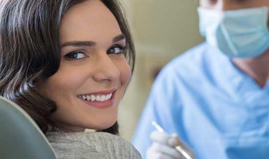 Picture of a woman, smiling at the camera, illustrating her happiness with the laser treatments she had in Costa Rica.