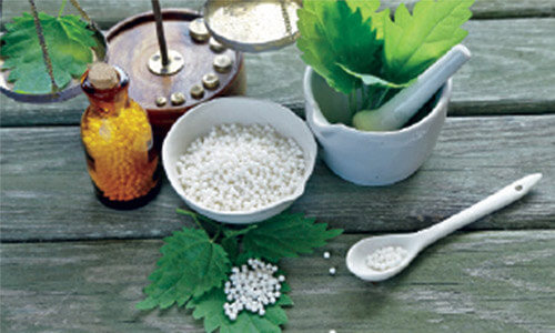 Picture of Homeopathic medicine used in dental work.  The picture shows a bowl and a bottle with Homeopathic medicine.